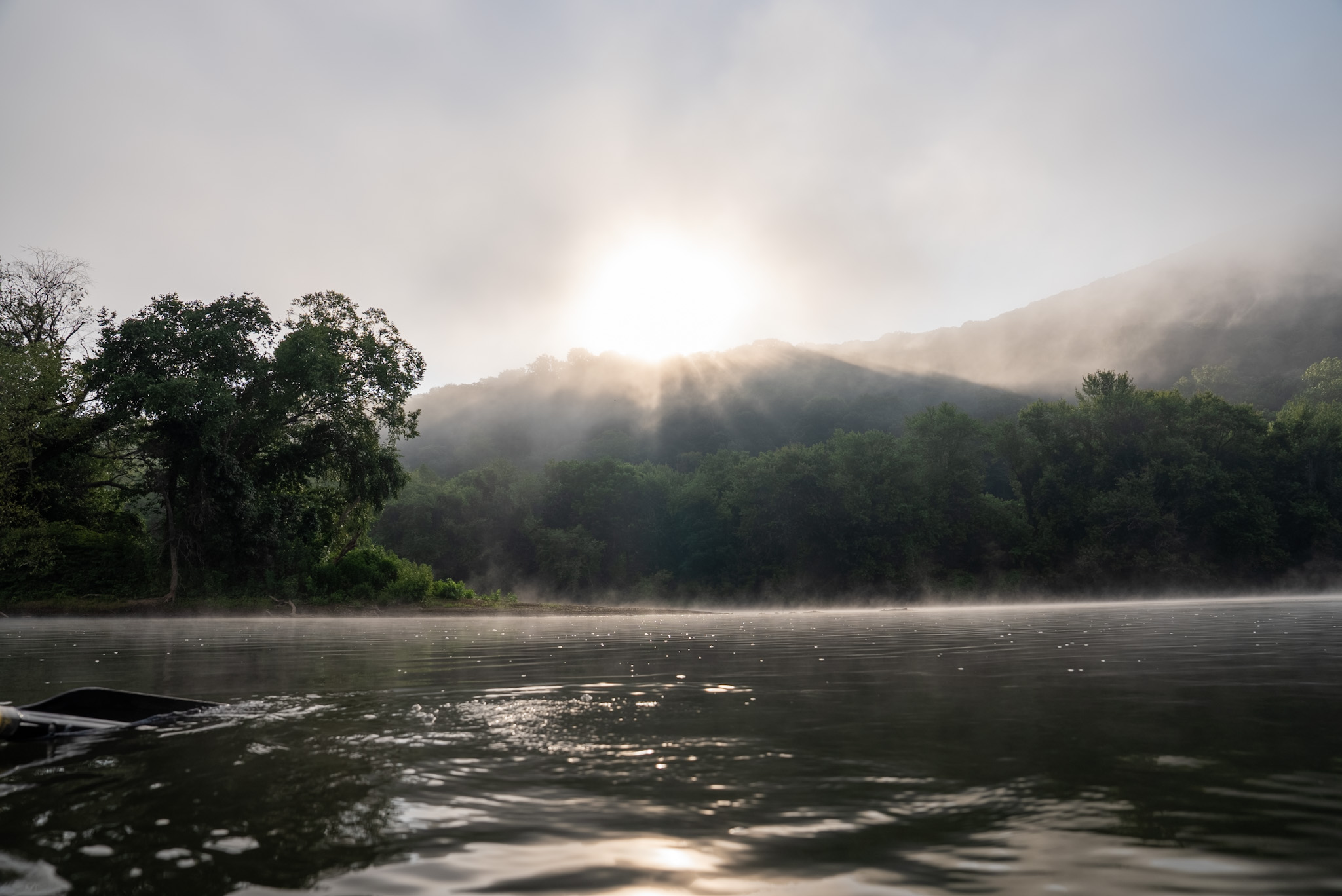 Fog over quiet trout water in the morning